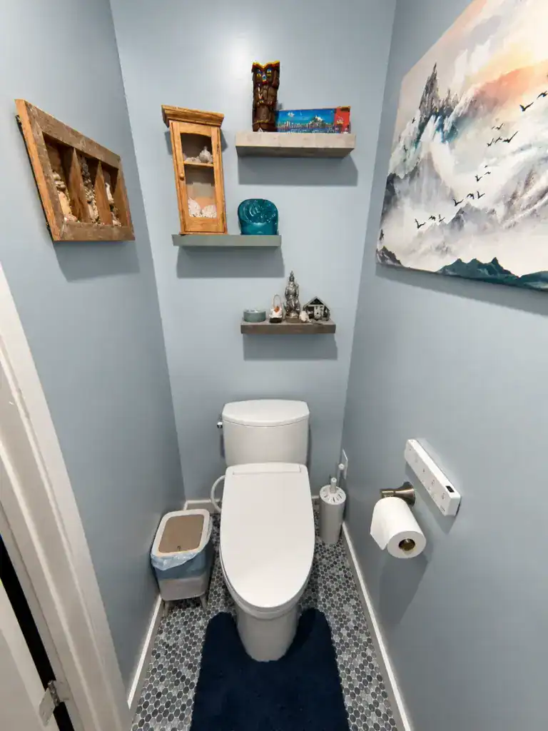 Small East Bay toilet room after a $10,000 bathroom remodel with new mosaic tile floor, bidet toilet, and floating shelves
