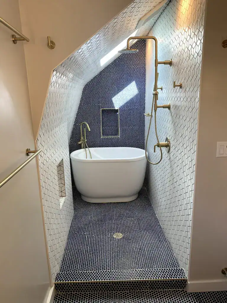 Custom wet room bathroom remodel in San Francisco with freestanding bathtub, mosaic tile, handheld shower, and skylight