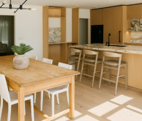 A warm contemporary kitchen combining natural wood cabinetry with dramatic marble surfaces and an open dining layout. Walnut Creek - Modern open-concept kitchen remodel featuring light oak flat-panel cabinets, marble waterfall island, integrated appliances, and adjacent dining area.